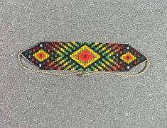 This beautiful beaded necklace is hand-woven by the women of the Embera Chami Indigenous Tribe of Colombia Traditional Handwoven Choker As A Gift, Traditional Handwoven Festival Beads, Artisan Handwoven Rectangular Jewelry, Adjustable Traditional Beaded Necklaces For Festivals, Traditional Rectangular Necklace For Festivals, Traditional Multicolor Woven Beaded Bracelets, Traditional Adjustable Rectangular Necklaces, Traditional Adjustable Rectangular Necklace, Traditional Handwoven Choker Jewelry