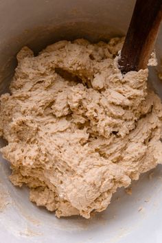 a bowl filled with batter and a wooden spoon sticking out of the top in it