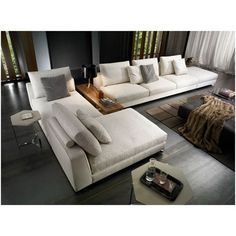 a living room filled with white couches and pillows