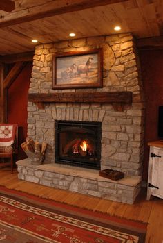 a living room with a fire place and rugs on the floor in front of it