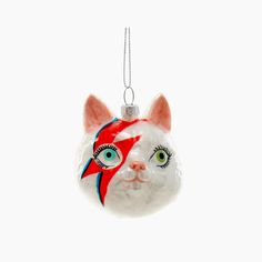 a glass ornament with a cat's face painted on the front and side