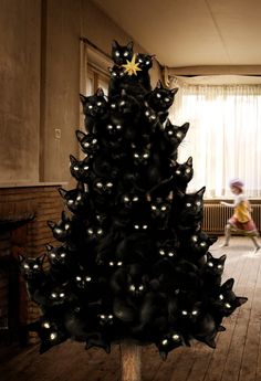 a black christmas tree with lights on it