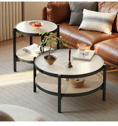 two coffee tables sitting next to each other on top of a carpeted living room floor