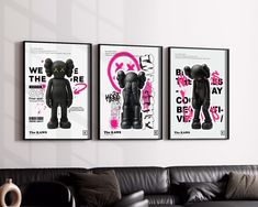 three posters are hanging on the wall above a couch in a room with black leather furniture