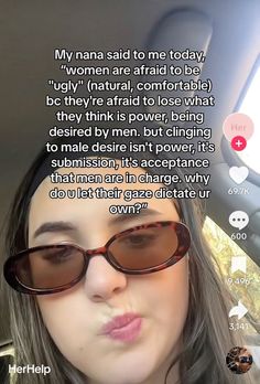 a woman wearing sunglasses is looking at the camera and has an interesting message on her face