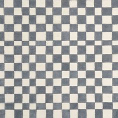 a gray and white checkered rug on the floor