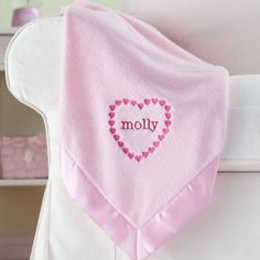 a pink blanket with the word moly written on it and a heart - shaped design