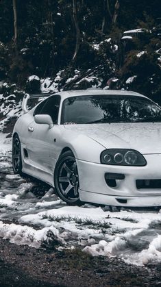 a white sports car parked in the snow