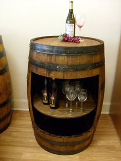 two wine glasses are sitting on top of a barrel