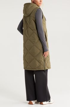 The beloved puffer vest moves beyond the between season with the warmth of a roomy hood and the coverage of a longer length. Zipped side vents let you regulate the temperature as needed. 39" length (size Medium) Front zip closure with snap storm placket Drawstring hood Chest zip pocket; front welt pockets Zip side vents Lined, with 100% recycled polyester 100% recycled polyester Machine wash, tumble dry Imported Sleeveless Down Puffer Jacket For Cold Weather, Functional Sleeveless Outerwear For Fall, Quilted Down Sleeveless Outerwear, Nylon Outerwear With Detachable Hood, Sleeveless Nylon Outerwear With Detachable Hood, Sleeveless Functional Puffer Jacket For Cold Weather, Sleeveless Down Puffer Jacket, Functional Sleeveless Down Outerwear, Athleisure Sleeveless Outdoor Outerwear