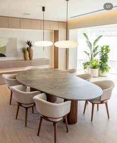 the dining room table is surrounded by beige chairs