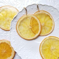 four slices of lemon on a white plate