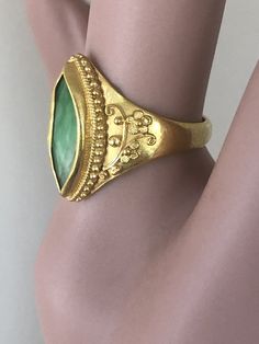 "Antique Chinese Qing Dynasty 22k Gold Navette JADEITE Ring size 6 Hand Crafted 5 grams The Navette Shaped Jadeite Measures: approximately 5 X 14mm The Jadeite is Hand Set in a sculptural Setting Hallmarked on the inside with a Chinese stamp The Qing dynasty , officially the Great Qing, also called the Empire of the Great Qing or the Manchu dynasty, was the last imperial dynasty of China, ruling from 1644 to 1912 with a brief, abortive restoration in 1917. It was preceded by the Ming dynasty and Gold Emerald Cabochon Ring For Formal Occasions, Antique Gold Emerald Cabochon Ring, Heirloom Gold Engraved Emerald Ring, Elegant 22k Gold Green Ring, Elegant Green 22k Gold Rings, Gold Byzantine Carved Jewelry, Byzantine Style Carved Gold Jewelry, Heirloom Gold Emerald Cabochon Ring, 22k Yellow Gold Emerald Ring