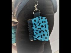 the back of a person's pants with a blue and black dog print keychain