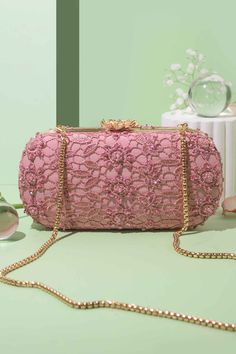 "Featuring our stunning pink lace cutwork clutch, adorned with delicate, pink-toned beads and cutdana adding an extra touch of elegance and charm. The beautiful cutwork adds depth and dimension to the clutch by allowing a glimpse of the lining beneath. Wear it gracefully on your shoulder allowing it to drape elegantly by your side for a sophisticated look or you can carry it in your hands for a more classic look. Color: Pink Dimensions (LxB): 8\"x4\" (20.3 cm X 10.1 cm) Handle length: 47\" (120 cm) Handle drop: 23\" (58 cm) Material: Lace cutwork fabric, suede lining, golden metal clutch frame, golden metal sling. Features: metal lock closure, detachable metal sling." Bridal Clutch Bag, Diwali Party, Wedding Clutch, Bridal Clutch, Box Clutch, Family Event, By Your Side, Evening Clutch Bag, Evening Clutch