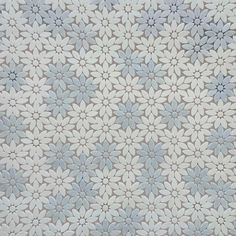 a white and blue flower pattern on a wallpaper with grey dots in the center