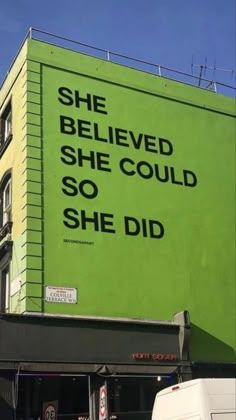 there is a large billboard on the side of a building that says she belived she could so she did