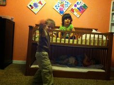 two children are playing in their crib