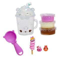 a cup filled with ice cream next to other plastic toys and items on a white background