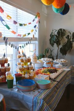 an assortment of desserts and cupcakes on a table