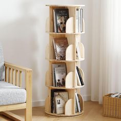 a wooden book shelf sitting in the corner of a living room next to a chair