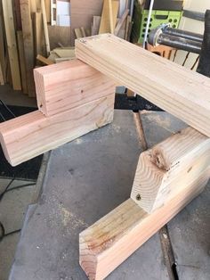 two pieces of wood sitting on top of a piece of plywood in a shop