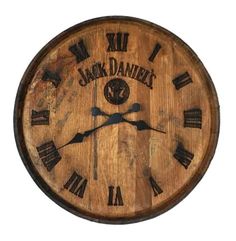 a wooden clock with roman numerals on it's face and the words jack daniels written in black