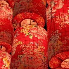 many red and yellow paper lanterns with flowers on them