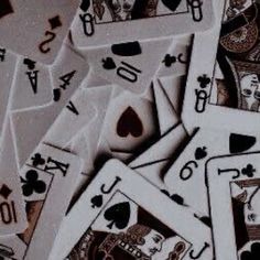 playing cards are scattered on top of each other