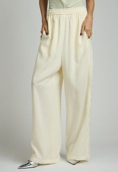 One size. Fits XS-MColor: CreamLightweight FabricDrawstring Waist100% TencelDry Clean By The NKC StoreProduct Measurements:Waist: 66.04cm / 26in Length: 104.77cm / 41.25in Beige Silk Wide-leg Pants, Beige Silk Wide Leg Bottoms, Silk Wide-leg Daywear Pants, Silk Wide-leg Pants For Daywear, White Silk Wide-leg Pants, Chic Beige Silk Bottoms, Silk Wide Leg Pants With Elastic Waistband, White Silk Bottoms For Summer, Wide Leg Silk Pants With Elastic Waistband