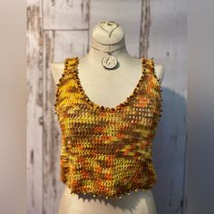 Crochet Tank Top With Coconut And Glass Accent Beads. Handmade In Bali. Orange, Yellow And Taupe. Fits S-M. Top Has Adjustable, Lace Up Back. Hand Or Gentle Machine Washable In Garment Bag. 100% Cotton Fitted Yellow Bohemian Crochet Top, Yellow Handmade Bohemian Top, Handmade Yellow Bohemian Top, Yellow Crochet Sleeveless Top, Yellow Bohemian Crochet Crop Top, Yellow Sleeveless Crochet Top For Festivals, Yellow Sleeveless Crochet Top, Yellow Bohemian Crochet Top, Sleeveless Yellow Crochet Top For Festival