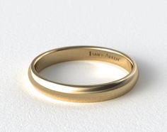 a close up view of a wedding ring on a white surface