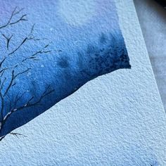 a watercolor painting of a tree with no leaves on it and blue sky in the background