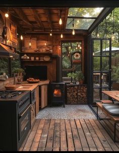 an outdoor kitchen with wood flooring and lighting