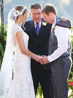 a bride and groom standing next to each other at the alter during their wedding ceremony