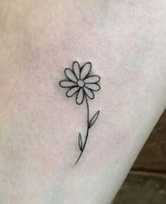 a small flower tattoo on the ankle