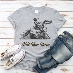 "Hello there Hold Your Horses Rodeo T Shirt, Horse Shirt, Cowboy, Women Wild West Funny Tees Shirts, Western Cowgirl Cute Short Sleeve Tops.Rodeo Gift, Women Hold Your Horses Letter Print Funny Graphic Tees, Vacation Casual T Shirt.Suitable for Beer Festival, Rodeo, Country Music, Drinking Party, Concert, Vacation, Mothers Day, Christmas Day, Birthday, Women, Mom, Her, Wife, Sister, Friends, Teacher. Browse our selection of funny shirts: https://www.etsy.com/listing/960709709/hold-your-horses-t- Casual Short Sleeve T-shirt With Horse Design, Casual Short Sleeve Tops With Horse Design, Casual Short-sleeved T-shirt With Horse Design, Casual Cotton T-shirt With Horse Design, Short Sleeve Cotton Top With Horse Design, Cotton Short Sleeve Top With Horse Design, Women Wild West, Cute Short Sleeve Tops, Cowboy Cute