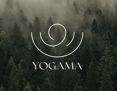 the logo for yogama is surrounded by fog and pine trees in the foreground