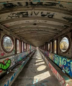 an abandoned tunnel with graffiti all over it