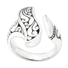 Elegance is at your fingertips when you wear this simple yet stunning ring from Dewa Arimbawa. Crafted from sterling silver the ring features a small opening at the front where its two ends meet. Traditional Balinese engravings give the ring an exquisite touch. Sterling Silver Engraved Open Ring, Classic Sterling Silver Bypass Open Ring, Classic Sterling Silver Open Bypass Ring, Sterling Silver Open Bypass Ring, Elegant Adjustable Sterling Silver Bypass Ring, Ceremonial Sterling Silver Open Ring, Handmade Silver Filigree Open Ring, Sterling Silver Filigree Open Ring Hallmarked, Handmade Sterling Silver Swirl Rings