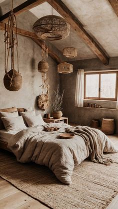 a bed sitting in a bedroom next to a window and wooden beams on the ceiling