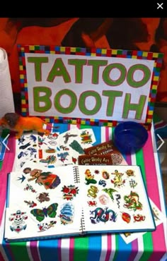 a table topped with lots of tattoos on top of a colorful cloth covered tablecloth