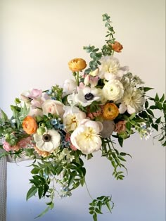 a vase filled with lots of flowers on top of a table