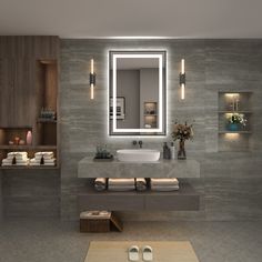 a bathroom with a sink, mirror and lights on the wall next to it's counter