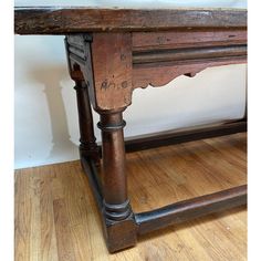 an old wooden table with two legs on the top and one leg up against it