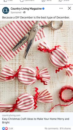 a pair of scissors sitting on top of red and white striped fabric with ribbon around them