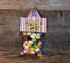 a bag filled with jelly beans sitting on top of a wooden floor next to a wall