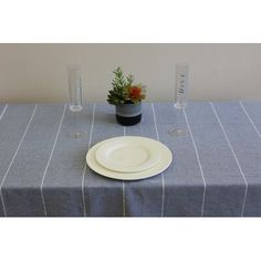 a white plate sitting on top of a blue table cloth