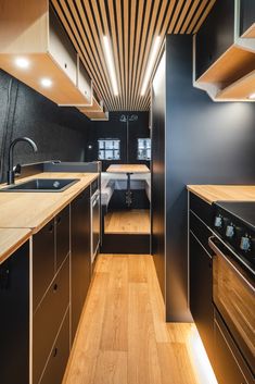 a kitchen with wooden floors and black walls