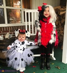 two children dressed up in costumes standing next to each other